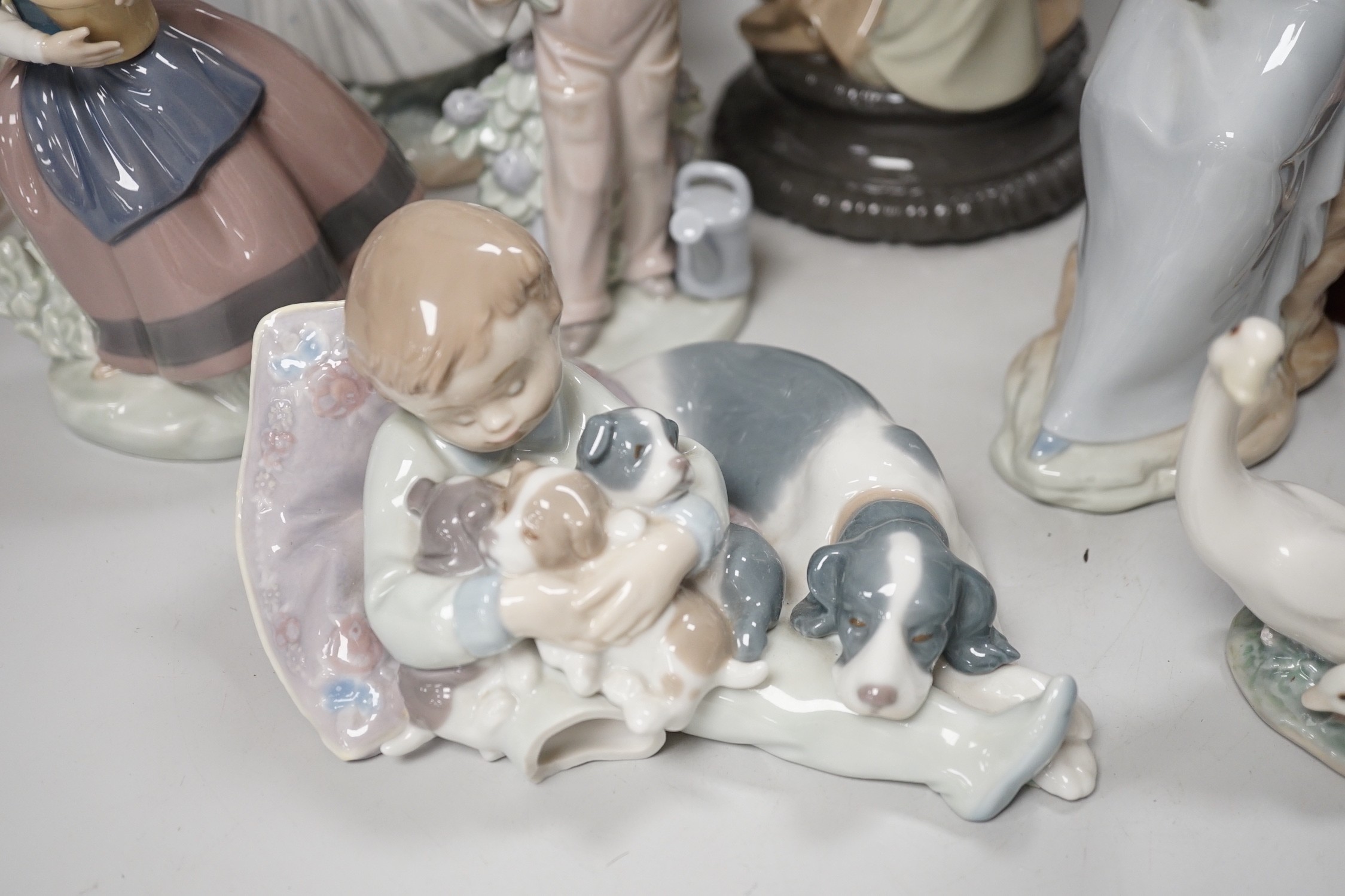 Seven Lladro and two Nao porcelain figures together with another, stuck to base so mark can’t be seen. Tallest 38cm
